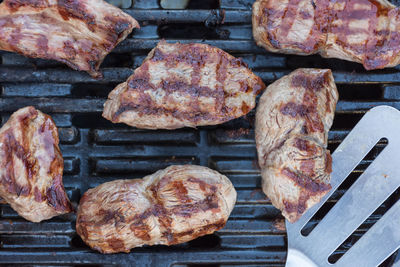 High angle view of meat on barbecue grill