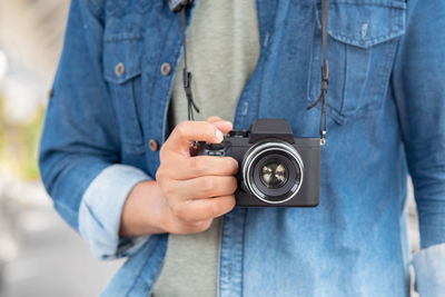 Midsection of man with camera