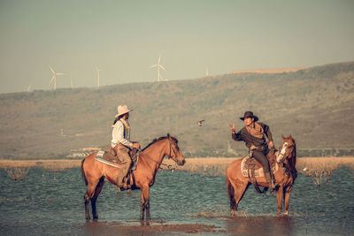 People riding horse cart on land