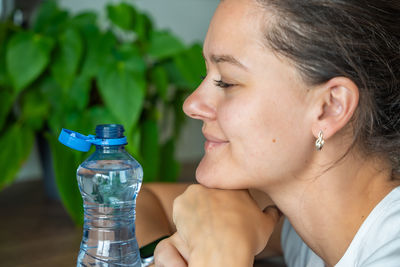 Close-up of young woman drinking water
