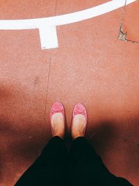 Low section of woman standing on court