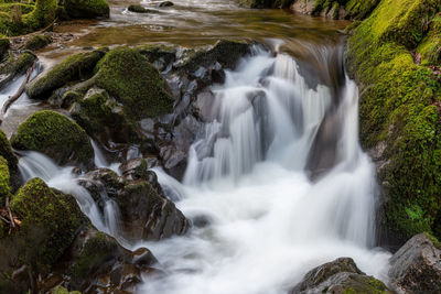 Long exposure of a waterfall flowing over rocks at watersmeet in exmoor national park