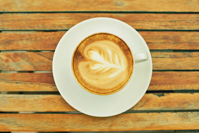 Directly above shot of cappuccino served on table