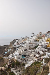 Townscape by sea against clear sky