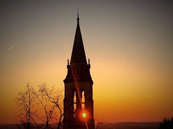 Silhouette temple against sky during sunset