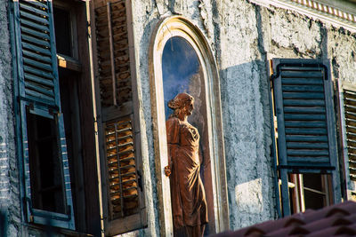 Low angle view of statue against historic building