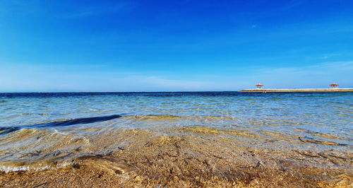 Scenic view of sea against blue sky