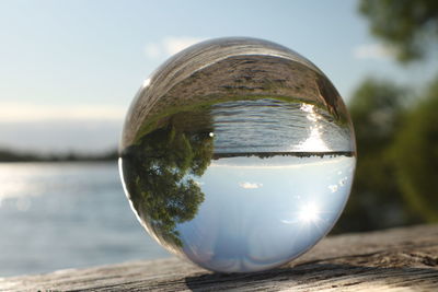 Close-up of crystal ball on wooden table