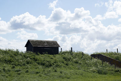 House on field against sky