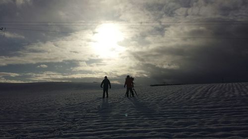 People on beach against sky