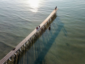 Aerial view look down wooden bridge with shadow at clan jetty,