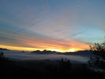 Scenic view of silhouette mountains against sky during sunset