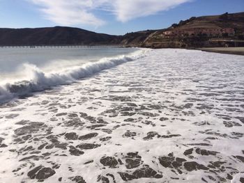 Scenic view of sea against cloudy sky