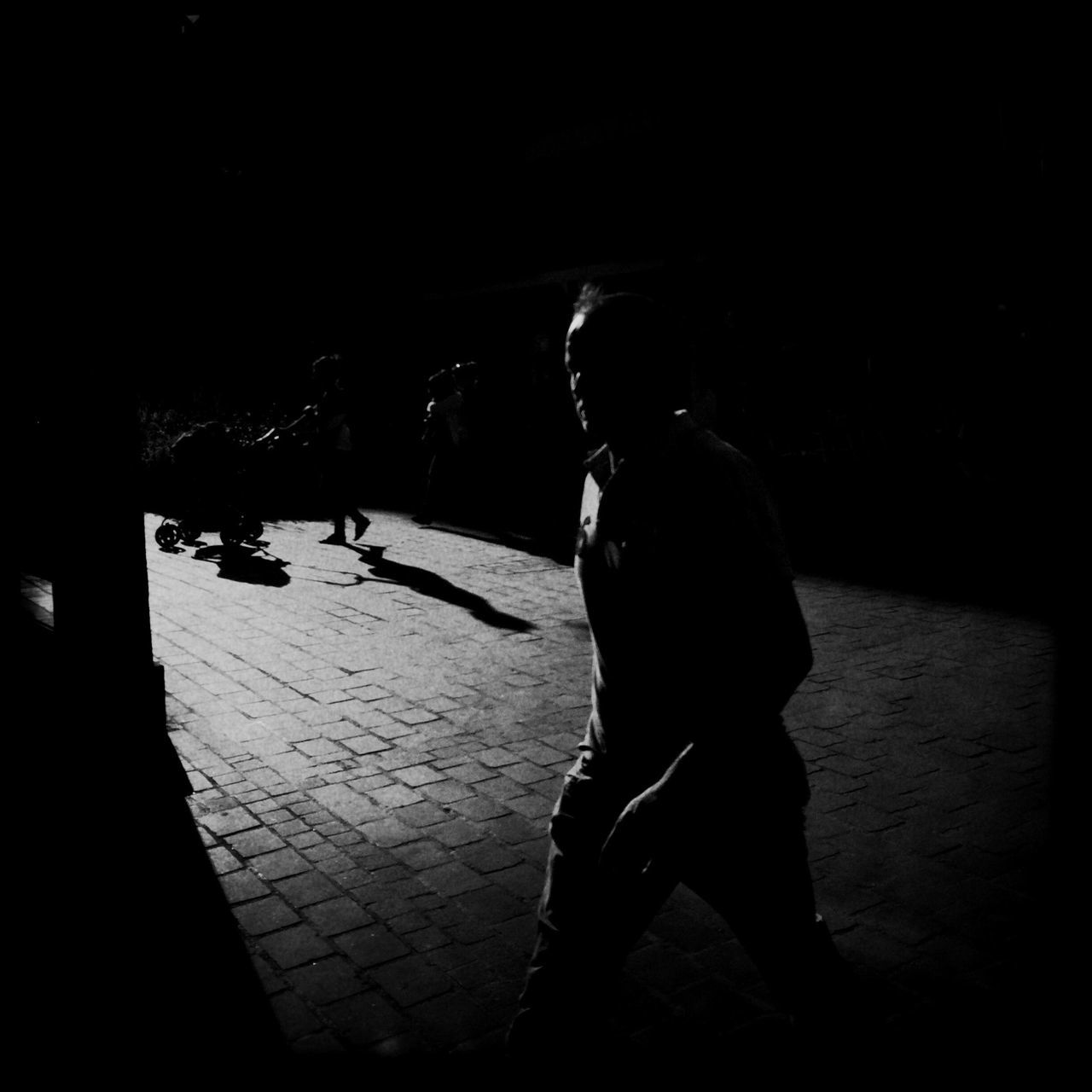 lifestyles, leisure activity, night, full length, men, street, shadow, casual clothing, standing, silhouette, rear view, person, side view, walking, sunlight, outdoors, dark, sidewalk