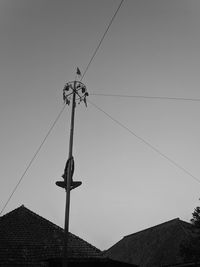 Low angle view of electricity pylon against sky