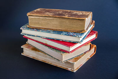 Close-up of books on table against black background