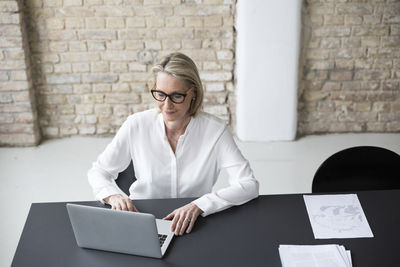 Mature businesswoman working in office