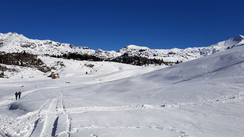 Scenic view of snowcapped mountains against clear sky