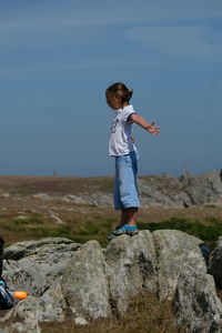 Full length of woman standing on rock