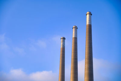 Low angle view of smoke stack against sky