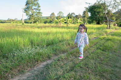 Full length of girl on field