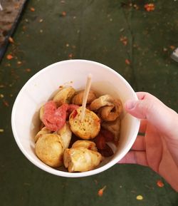 High angle view of hand holding food in bowl