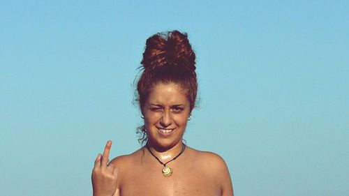 Portrait of woman giving the finger