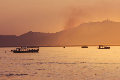 Scenic view of sea against orange sky