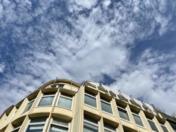 Low angle view of building against cloudy sky