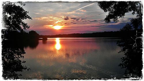 Scenic view of lake at sunset