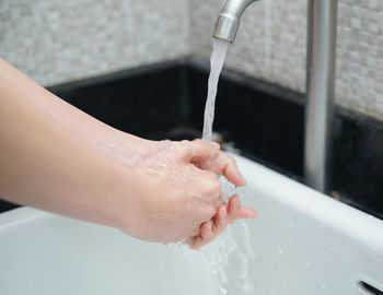 Midsection of man in bathroom at home