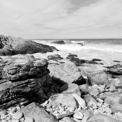 Rocks on beach against sky