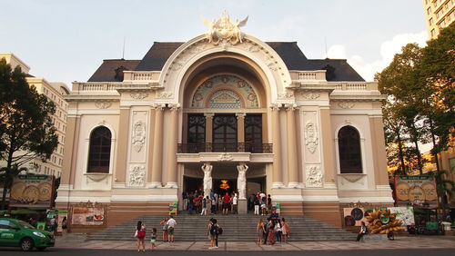 People in front of building against sky