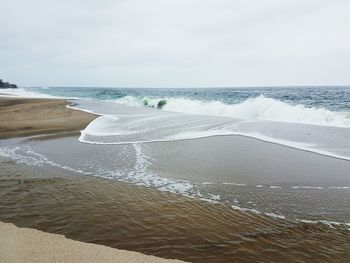 Scenic view of beach against sky