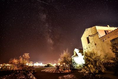 Low angle view of houses against sky at night