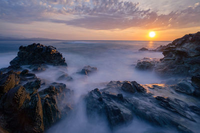 Scenic view of sea against sky during sunset