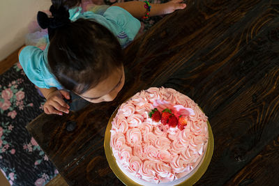 High angle view of girl by cake