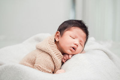 High angle view of baby sleeping on bed