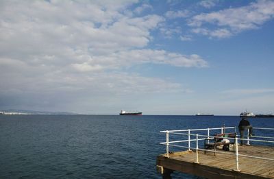 Scenic view of sea against cloudy sky