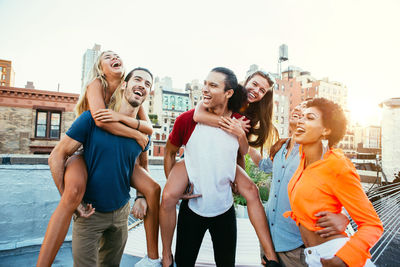 Happy friends on building terrace