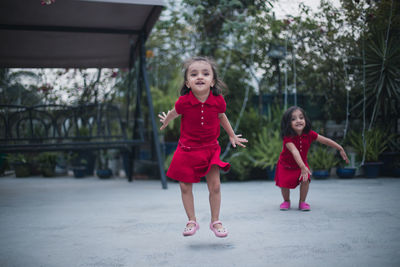 Twin sisters standing in backyard