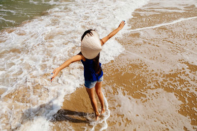 Full length of girl jumping on beach