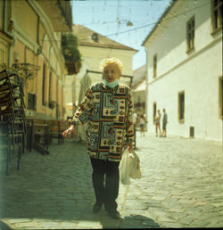 Man standing on street against building