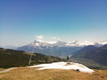 Scenic view of snowcapped mountains against blue sky