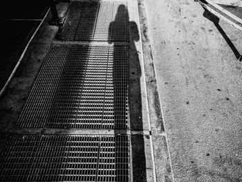 High angle view of shadow on metal grate