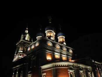 Low angle view of illuminated building against sky at night