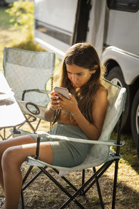 Girl at camping using cell phone