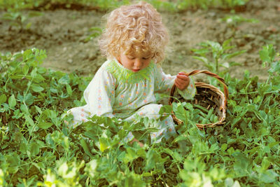 Portrait of girl standing amidst plants