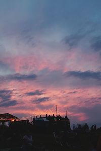 Silhouette city against sky at sunset