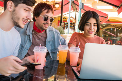 Young man and woman using smart phone